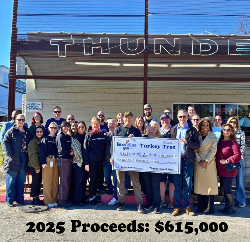 ThunderCloud Subs team presenting a $615,000 check to Caritas of Austin, 2025 Turkey Trot proceeds